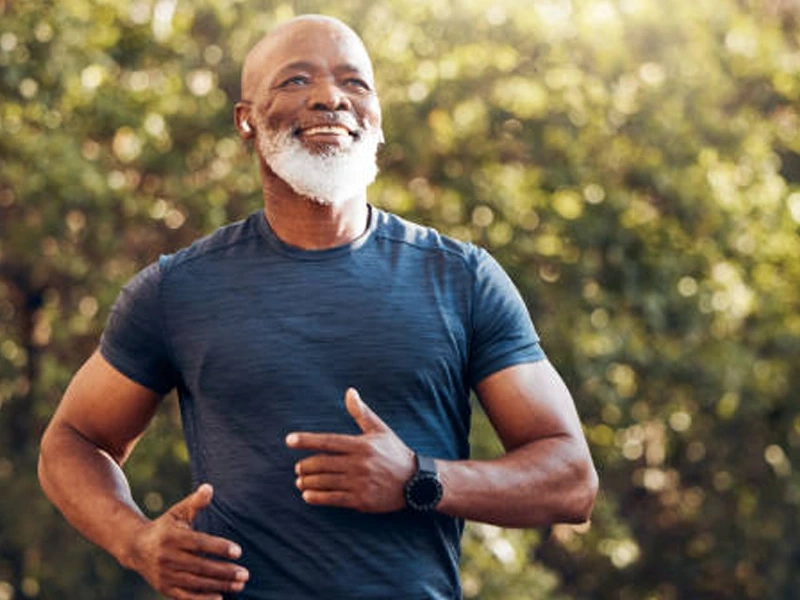 Energetic mature man jogging outdoors and feeling his best