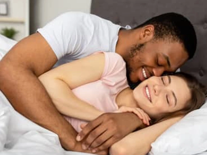 Smiling couple relaxing and embracing together